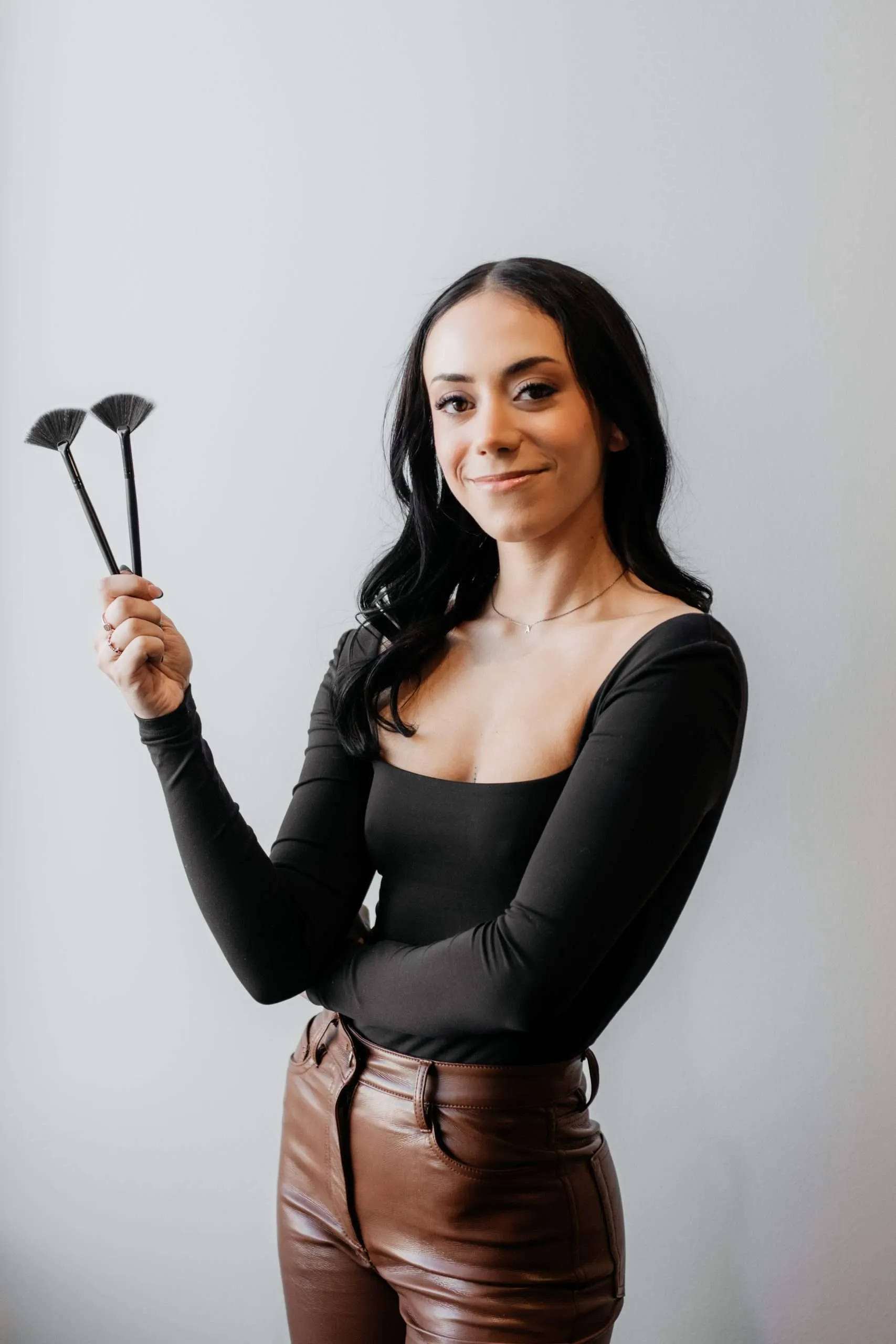 Urbane Beauty esthetician holding professional fan brushes
